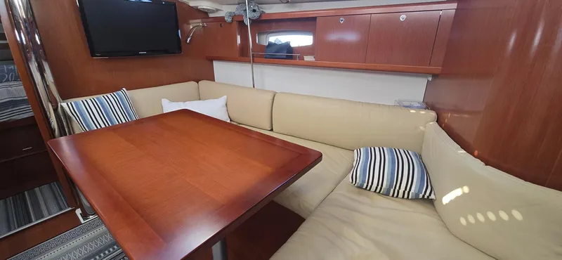 Sognare Yacht Photos Pics Interior of 2011 Beneteau Oceanis 40 yacht with cozy seating and wooden table.