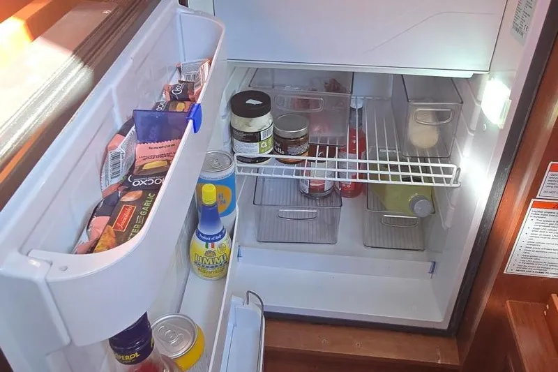 Sognare Yacht Photos Pics Refrigerator inside 2011 Beneteau Oceanis 40 yacht, stocked with various food items and condiments.