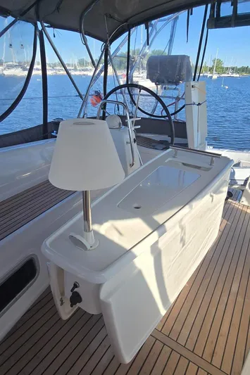 Sognare Yacht Photos Pics Beneteau Oceanis 40 cockpit with wooden deck, steering wheel, and lamp, 2011 model.