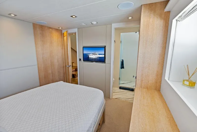  Yacht Photos Pics Luxurious bedroom interior of 2014 Horizon RP 110 yacht with modern decor and ensuite bathroom.
