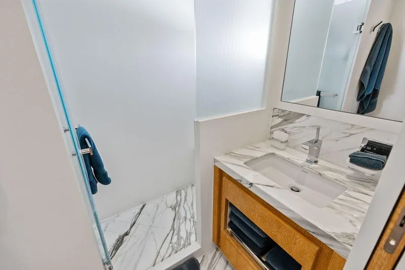  Yacht Photos Pics Luxurious bathroom in 2014 Horizon RP 110 yacht with marble sink and modern shower.