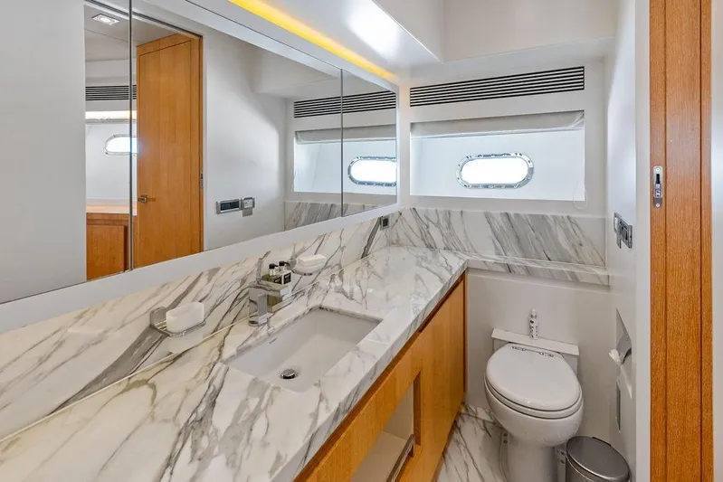  Yacht Photos Pics Luxurious yacht bathroom with marble countertop, modern fixtures, and porthole window on Horizon RP 110, 2014.