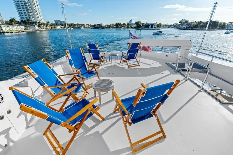  Yacht Photos Pics Deck of 2014 Horizon RP 110 yacht with blue chairs overlooking water.