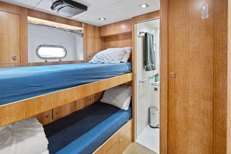  Yacht Photos Pics Bunk beds in Horizon RP 110 yacht cabin, 2014 model, with wooden interior and small bathroom.