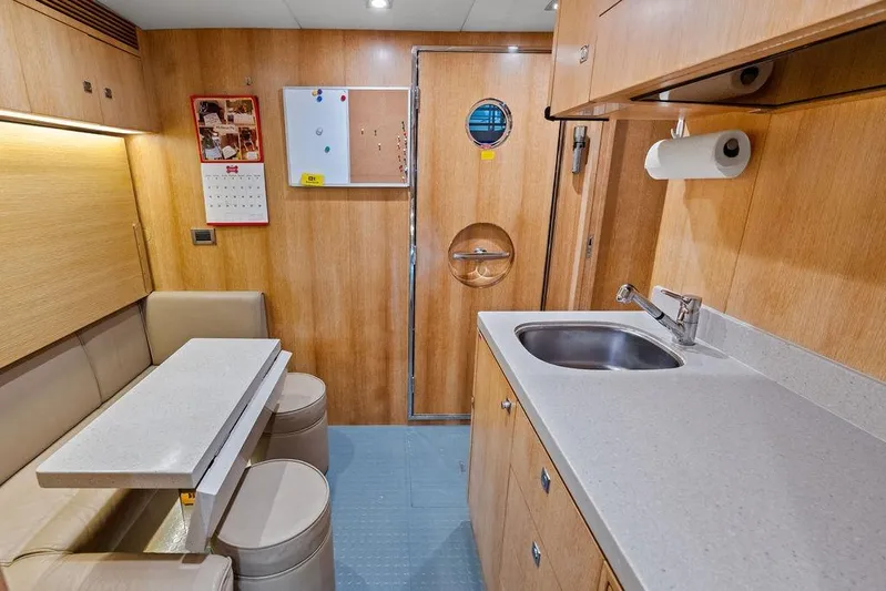  Yacht Photos Pics Compact kitchen and dining area in 2014 Horizon RP 110 yacht interior.