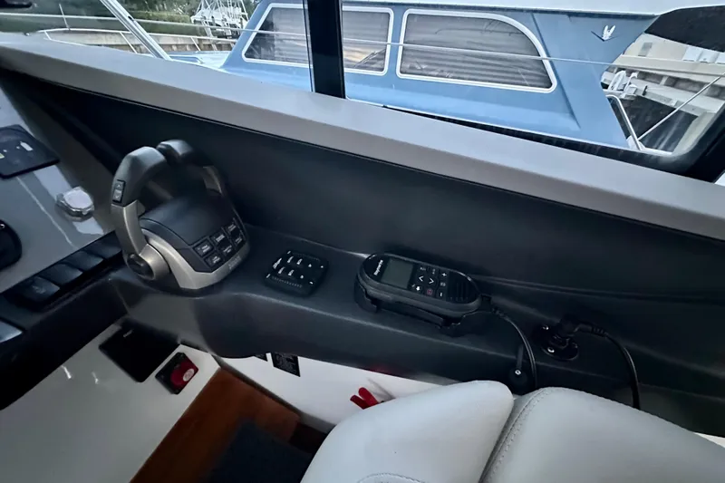 Bejul Yacht Photos Pics Interior of 2021 Princess V40 yacht cockpit with control panel and communication device.