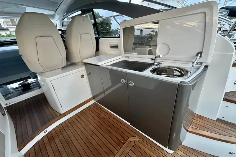 Bejul Yacht Photos Pics Luxurious 2021 Princess V40 yacht interior with sleek kitchenette and comfortable seating.
