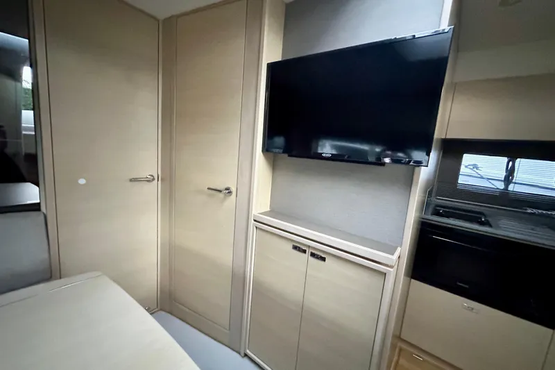 Bejul Yacht Photos Pics Interior of 2021 Princess V40 yacht with TV and modern cabinetry.
