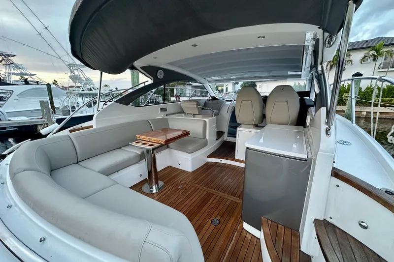 Bejul Yacht Photos Pics Luxurious 2021 Princess V40 yacht interior with elegant seating and wooden flooring.