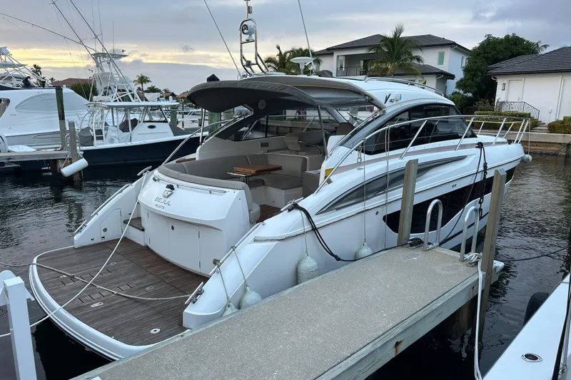 Bejul Yacht Photos Pics Luxury 2021 Princess V40 yacht docked at marina, showcasing sleek design and spacious deck.