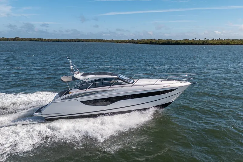 Bejul Yacht Photos Pics 2021 Princess V40 yacht cruising on open water under a clear blue sky.