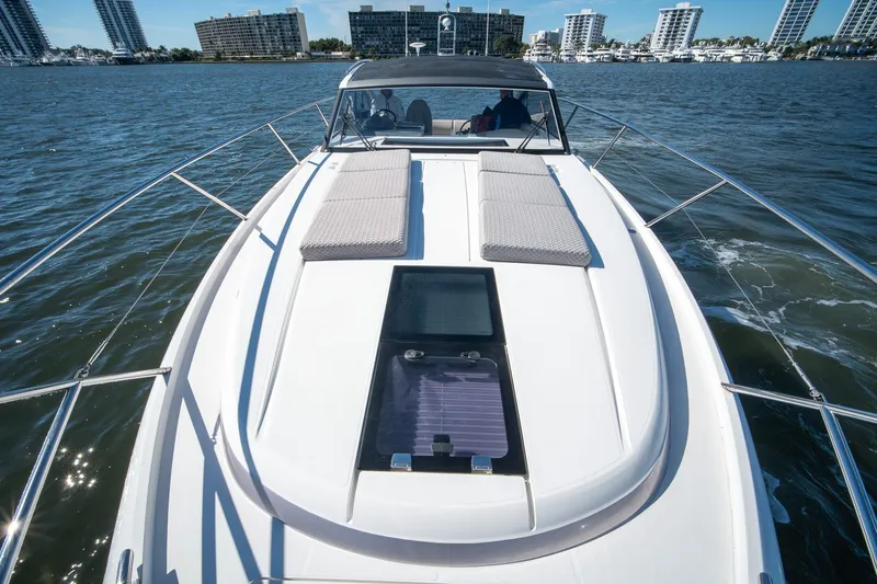 Bejul Yacht Photos Pics 2021 Princess V40 yacht cruising on water with city skyline in background.