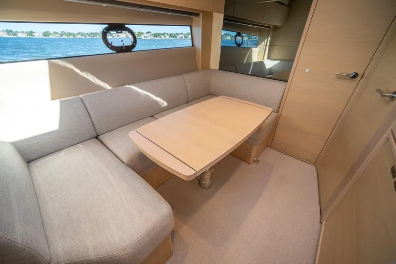 Bejul Yacht Photos Pics Luxurious interior of 2021 Princess V40 yacht with elegant seating and table.