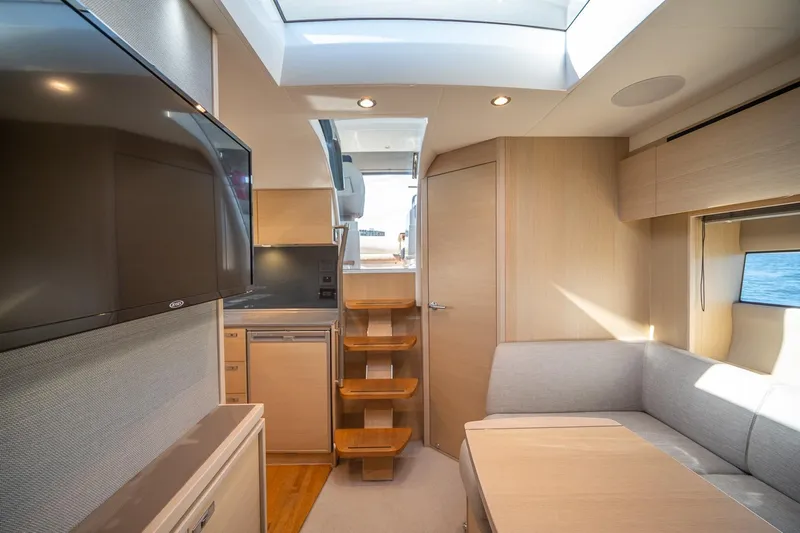 Bejul Yacht Photos Pics Interior of 2021 Princess V40 yacht with modern design, skylight, and cozy seating area.