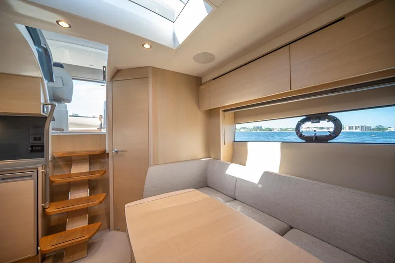 Bejul Yacht Photos Pics Luxurious interior of 2021 Princess V40 yacht with modern seating and scenic window view.