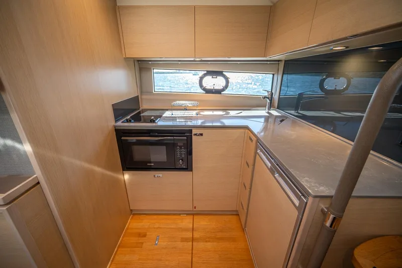 Bejul Yacht Photos Pics Modern kitchen interior on 2021 Princess V40 yacht with sleek cabinetry and appliances.