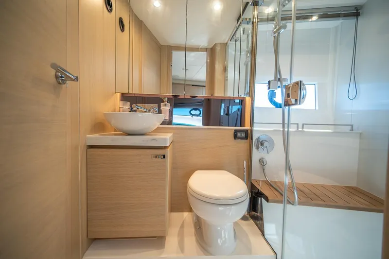 Bejul Yacht Photos Pics Luxurious bathroom in 2021 Princess V40 yacht with modern fixtures and wooden accents.