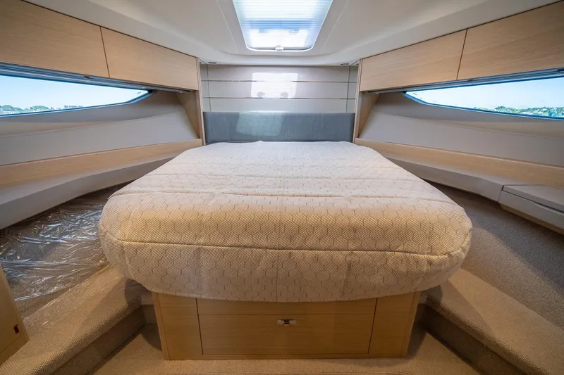 Bejul Yacht Photos Pics Luxurious interior cabin of 2021 Princess V40 yacht with elegant bedding and wood finishes.
