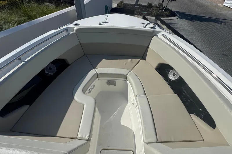 Blue Horizons II Yacht Photos Pics 2023 Boston Whaler 240 Vantage boat interior with cushioned seating and speakers.