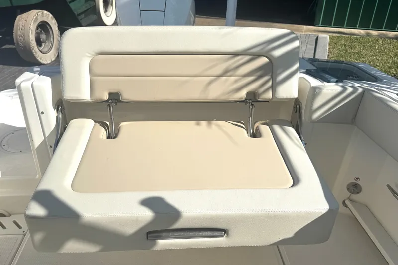 Blue Horizons II Yacht Photos Pics 2023 Boston Whaler 240 Vantage boat seat, beige upholstery, outdoor setting.