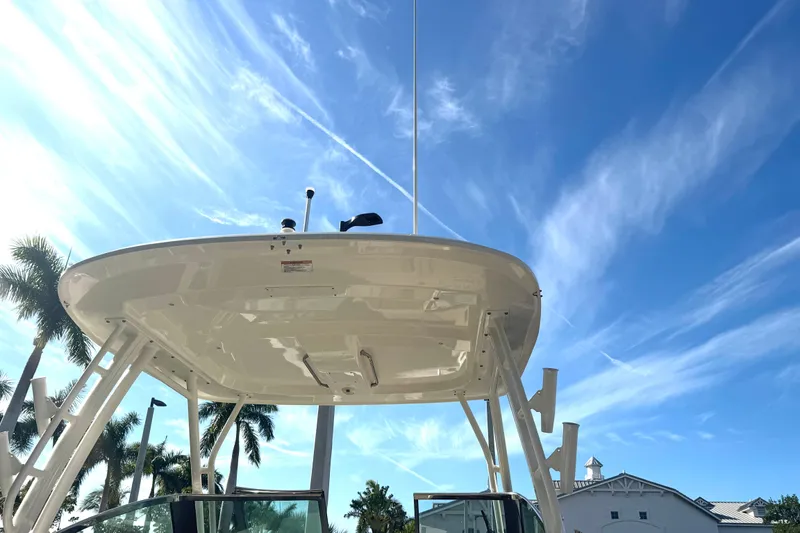 Blue Horizons II Yacht Photos Pics 2023 Boston Whaler 240 Vantage boat under clear blue sky with palm trees.