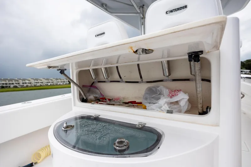  Yacht Photos Pics 2023 Contender 32 ST boat with open storage compartment and fishing gear.