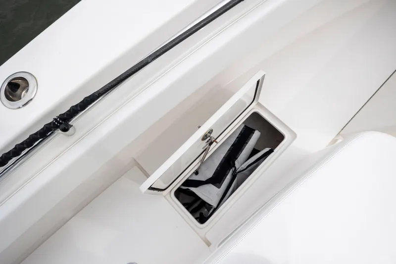  Yacht Photos Pics 2023 Contender 32 ST boat storage compartment with open hatch and visible contents.