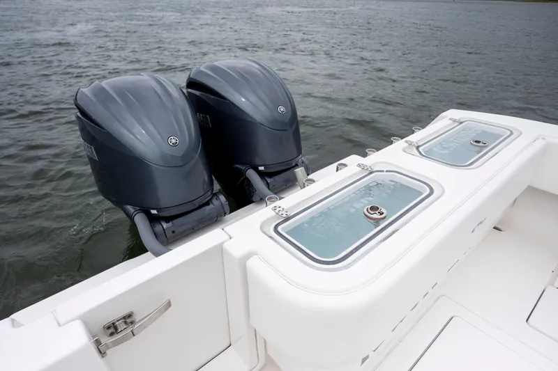  Yacht Photos Pics 2023 Contender 32 ST boat with dual outboard engines on water.