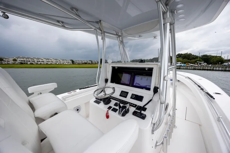  Yacht Photos Pics 2023 Contender 32 ST boat interior with modern navigation system and white seating.