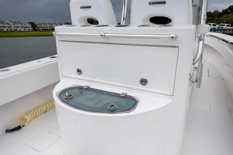  Yacht Photos Pics 2023 Contender 32 ST boat interior with storage and seating, near water.