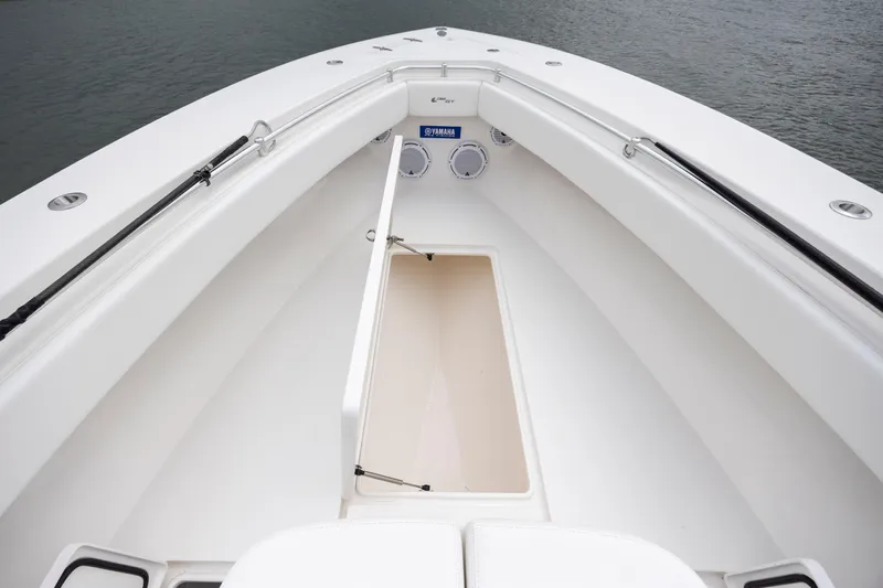  Yacht Photos Pics 2023 Contender 32 ST boat interior with storage compartment and Yamaha speakers.