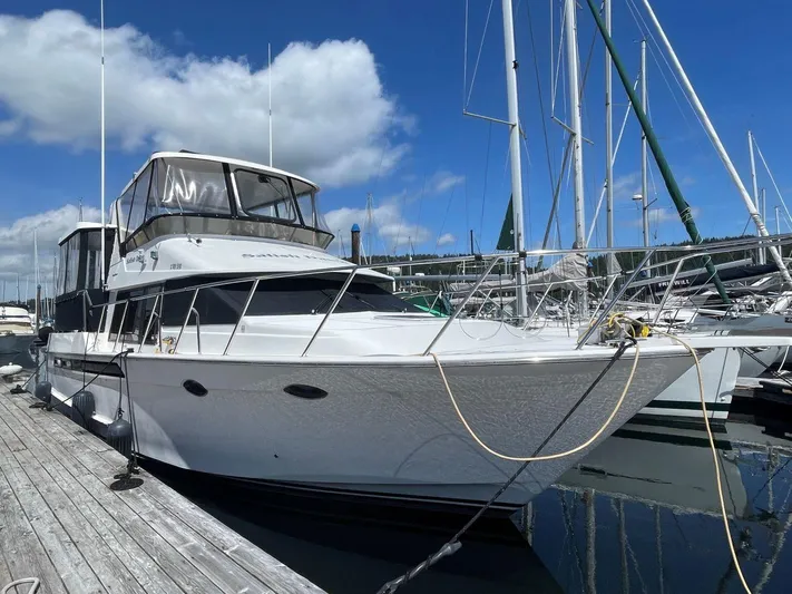  Yacht Photos Pics 1990 Ocean Alexander 440 Sundeck CPMY docked at marina under blue sky.