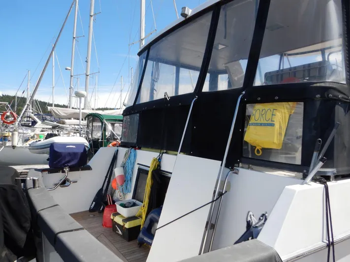  Yacht Photos Pics 1990 Ocean Alexander 440 Sundeck CPMY docked, featuring spacious deck and nautical equipment.