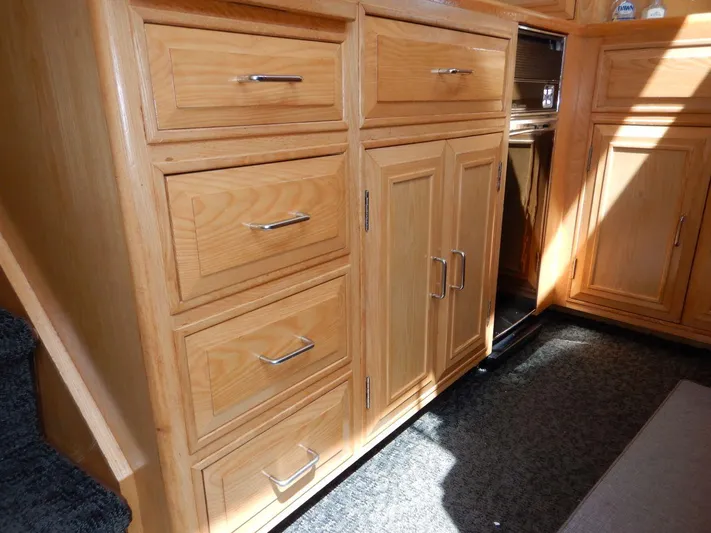  Yacht Photos Pics Interior cabinetry of 1990 Ocean Alexander 440 Sundeck CPMY, featuring wooden drawers and cabinets.