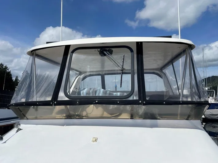  Yacht Photos Pics 1990 Ocean Alexander 440 Sundeck CPMY boat with clear enclosure under a blue sky.