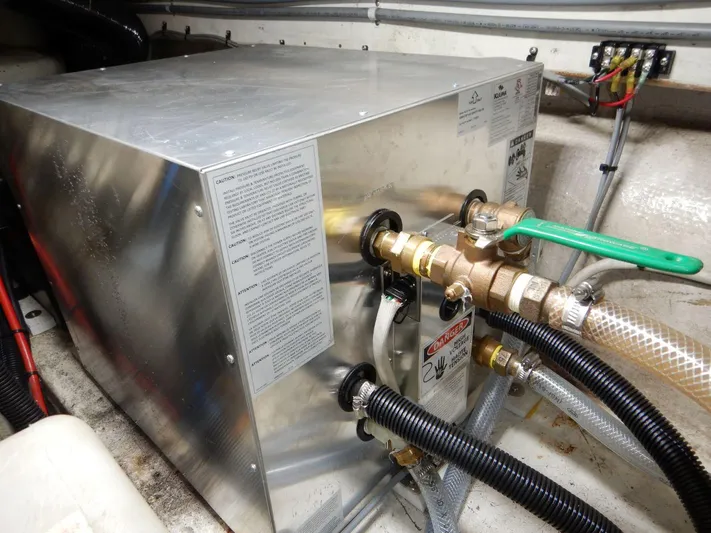  Yacht Photos Pics Engine room of 1990 Ocean Alexander 440 Sundeck CPMY with metal equipment and hoses.