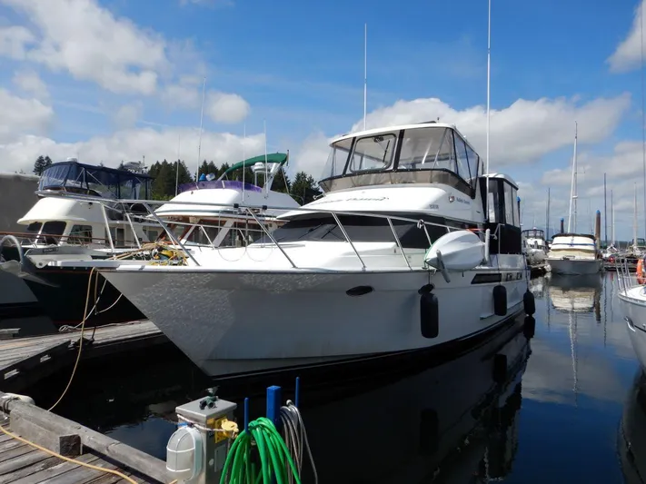  Yacht Photos Pics 1990 Ocean Alexander 440 Sundeck CPMY yacht docked at marina under blue sky.