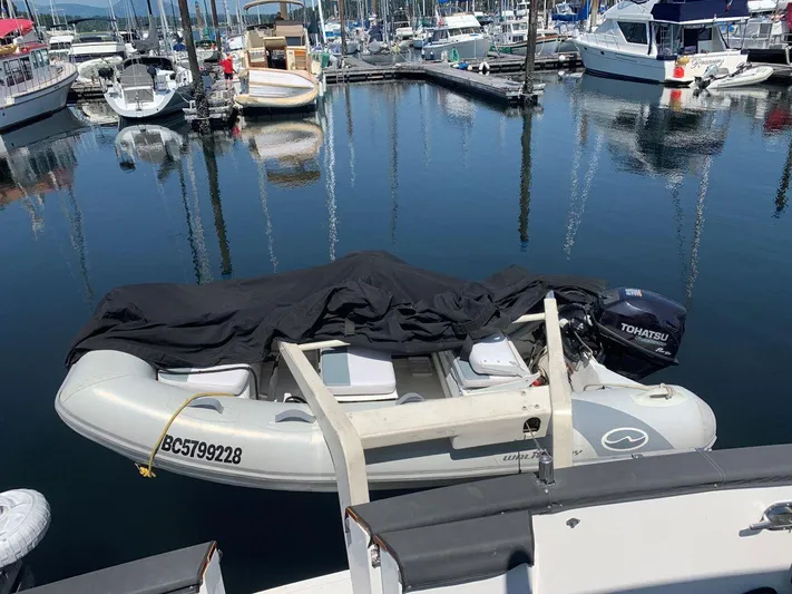  Yacht Photos Pics Inflatable boat with Tohatsu motor docked at marina, near Ocean Alexander 440 Sundeck CPMY, 1990.