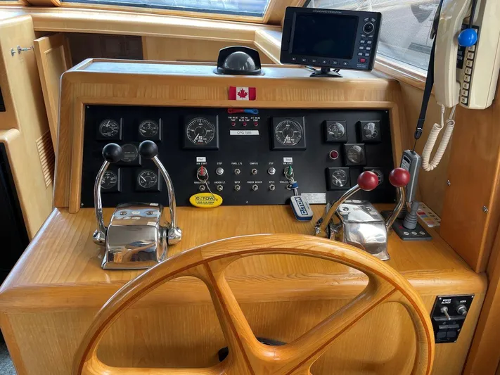  Yacht Photos Pics 1990 Ocean Alexander 440 Sundeck CPMY helm with controls, gauges, and navigation equipment.