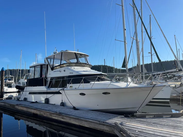  Yacht Photos Pics 1990 Ocean Alexander 440 Sundeck CPMY yacht docked at marina under clear blue sky.
