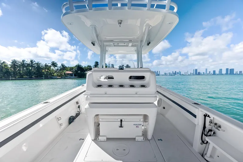 Double Trouble Yacht Photos Pics 2017 Intrepid 327 Center Console boat on clear water with city skyline.