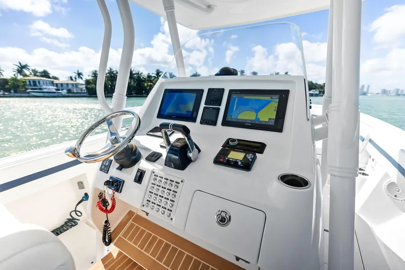 Double Trouble Yacht Photos Pics 2017 Intrepid 327 Center Console boat dashboard with navigation screens and steering wheel.
