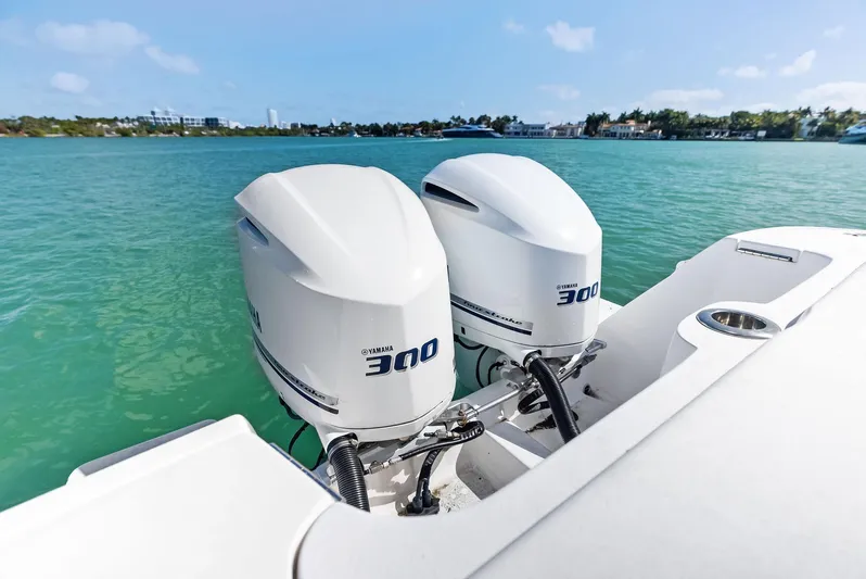 Double Trouble Yacht Photos Pics 2017 Intrepid 327 Center Console with twin outboard engines on turquoise water.