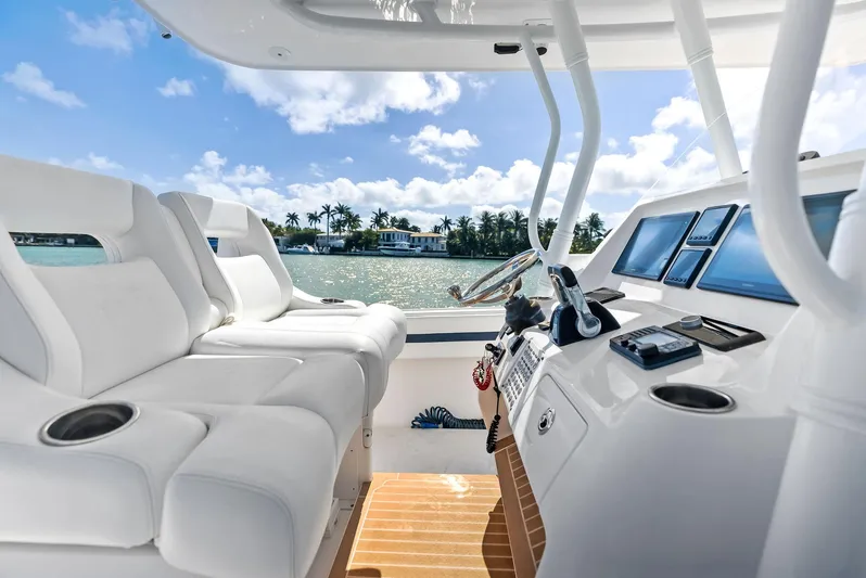 Double Trouble Yacht Photos Pics 2017 Intrepid 327 Center Console boat interior with white seating and control panel.