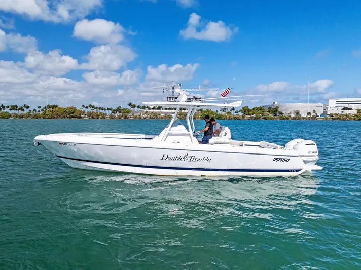 Double Trouble Yacht Photos Pics 2017 Intrepid 327 Center Console boat cruising on clear blue water.