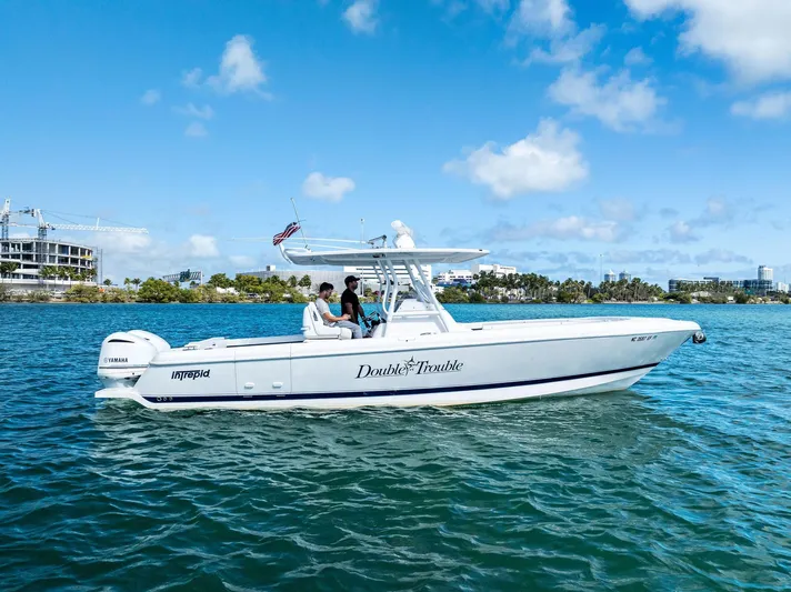 Double Trouble Yacht Photos Pics 2017 Intrepid 327 Center Console boat on water under blue sky.