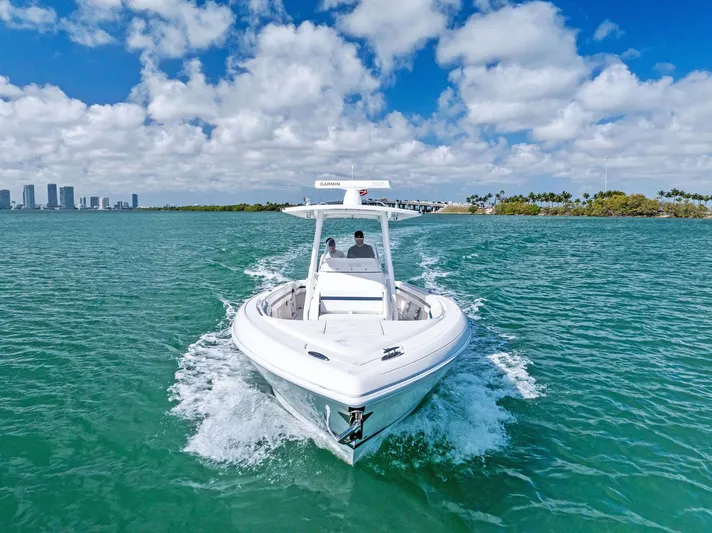 Double Trouble Yacht Photos Pics 2017 Intrepid 327 Center Console boat cruising on clear blue water.