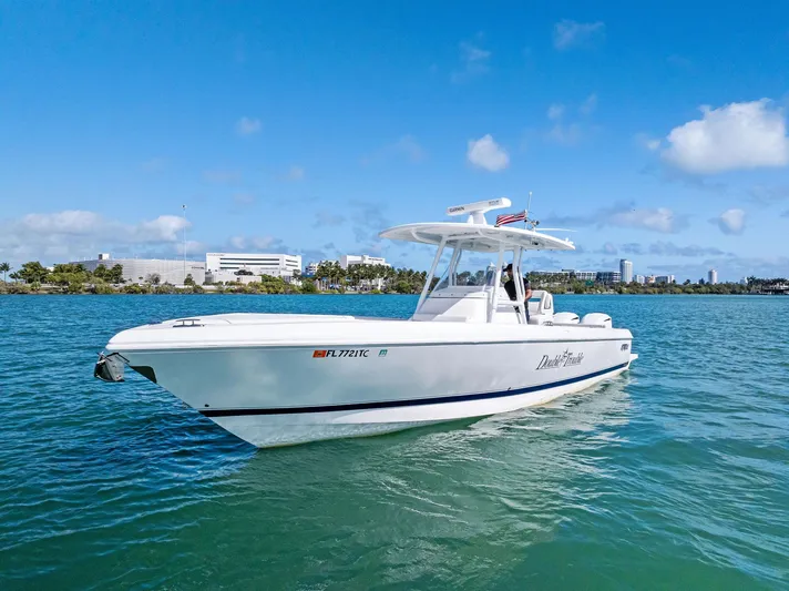 Double Trouble Yacht Photos Pics 2017 Intrepid 327 Center Console boat on clear blue water under a sunny sky.