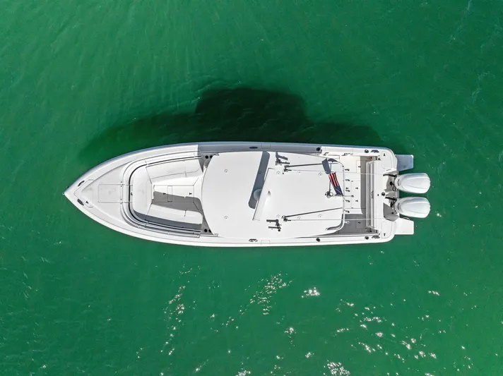 Double Trouble Yacht Photos Pics Aerial view of 2017 Intrepid 327 Center Console boat on green water.