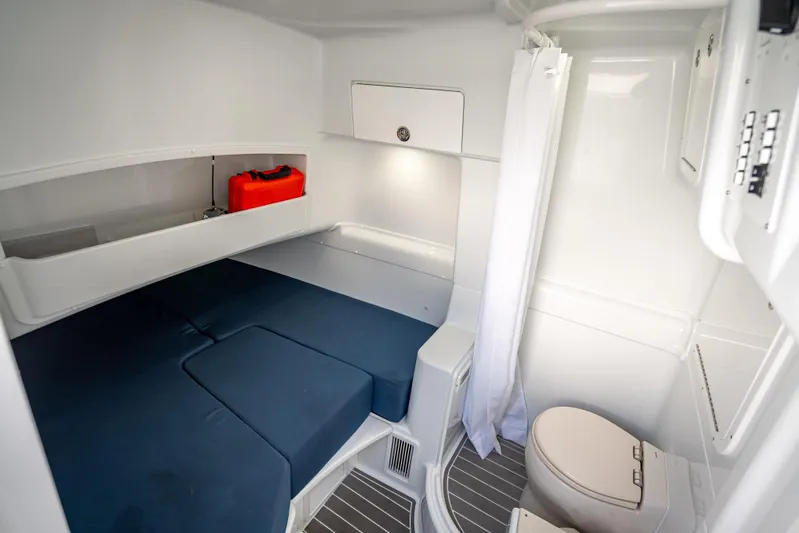  Yacht Photos Pics 2025 Yellowfin 42 Offshore cabin interior with bed, storage, and marine toilet.